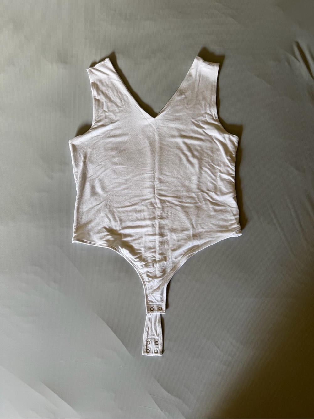 Women's White V-Neck Bodysuit with Snap Closure